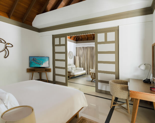 JA_Manafaru_Accommodation_Deluxe Beach Villa_Bedroom_2024.jpg